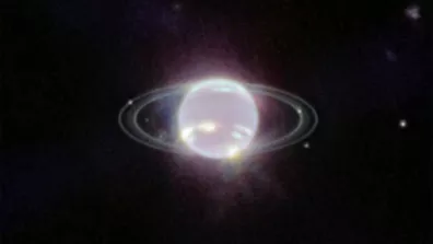 Les petits points blancs situés autour de la planète, parfois au milieu de ses anneaux, sont des lunes de Neptune. Image de la caméra infrarouge du télescope J. Webb (2022).