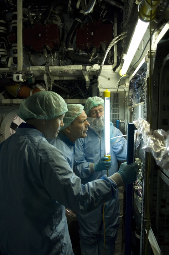 ESA astronaut Hans Schlegel inspects a payload rack inside the European Columbus laboratory. Credits: ESA - S. Corvaja