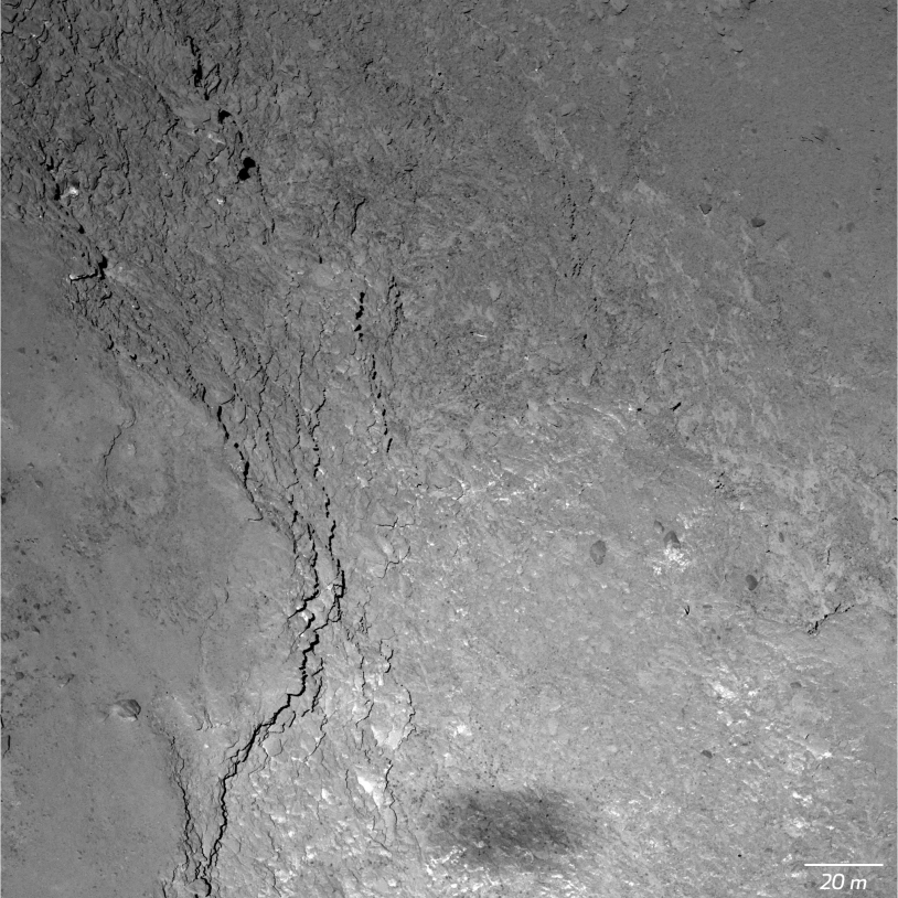 Gros plan de 67P (Imhotep) par la caméra OSIRIS-NAC, obtenu le 14 février 2015 à 6 000 m d’altitude (11 cm/pixel) ; l’ombre de Rosetta est visible en bas. Crédits : ESA/Rosetta/MPS for OSIRIS Team MPS/UPD/LAM/IAA/SSO/INTA/UPM/DASP/IDA.